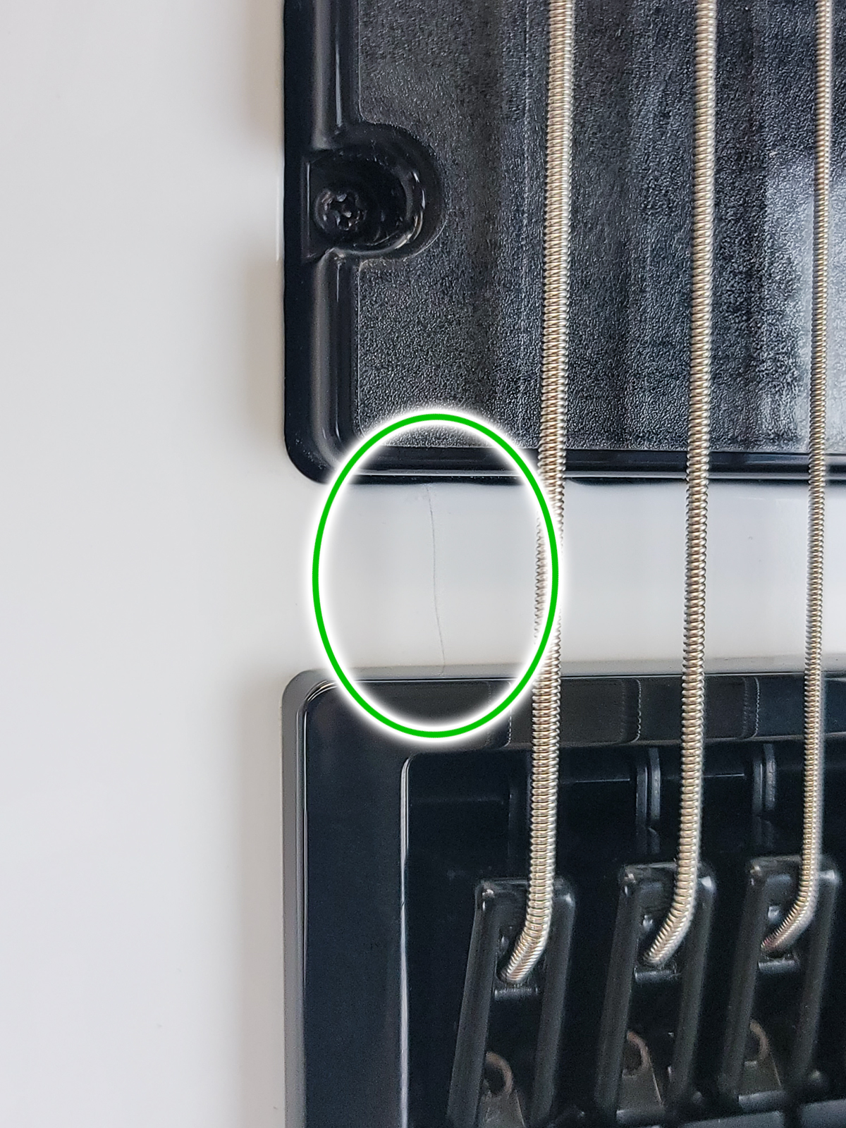 There is a small crack between the bridge and the bridge pickup. The crack has been glued and is stable.