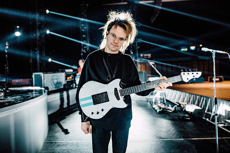 Rou with his EverTune F model custom Alpher Instruments aluminum topped Manta Elite